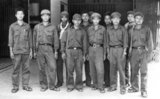 Tuol Sleng (S 21) Prison: A group of young Khmer Rouge prison guards, c.1977. Although permanently in danger of arrest themselves, these guards were privileged by DK standards - note the good quality uniforms, wrist watches and pens in top pockets, the latter indicative of senior rank. S-21, or Tuol Sleng, is a former high school which was used as the notorious Security Prison 21 (S-21) by the Khmer Rouge communist regime from its rise to power in 1975 to its fall in 1979. Tuol Sleng means "Hill of the Poisonous Trees" or "Strychnine Hill".