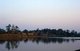 Cambodia: The entrance and moat surrounding Angkor Wat as the sun sets